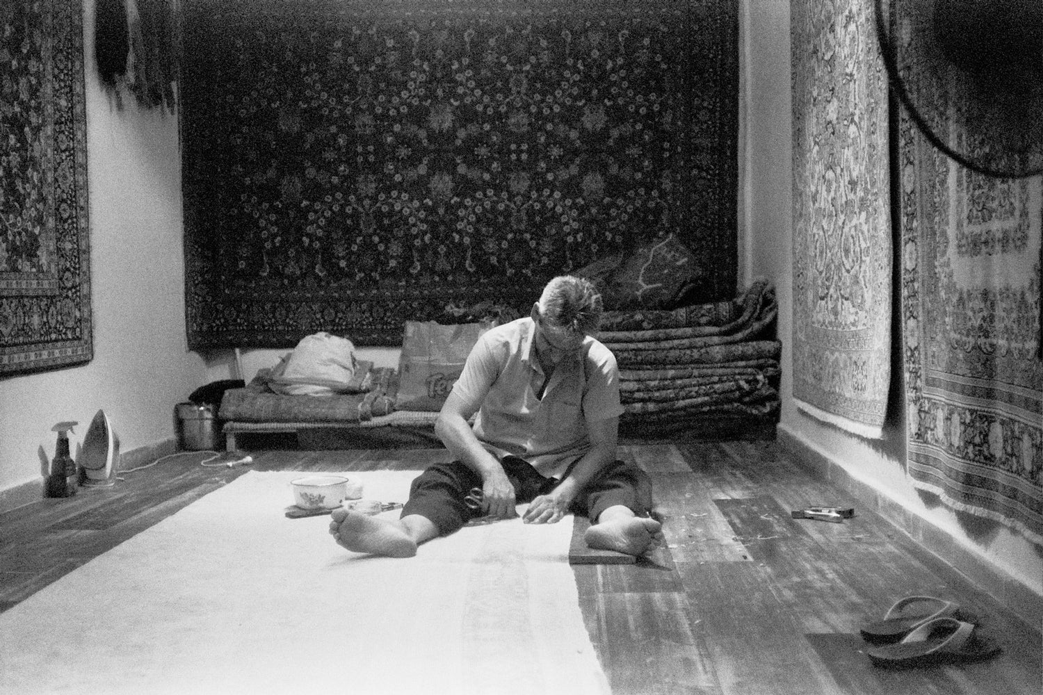 Ali Esmaili surrounded by rugs