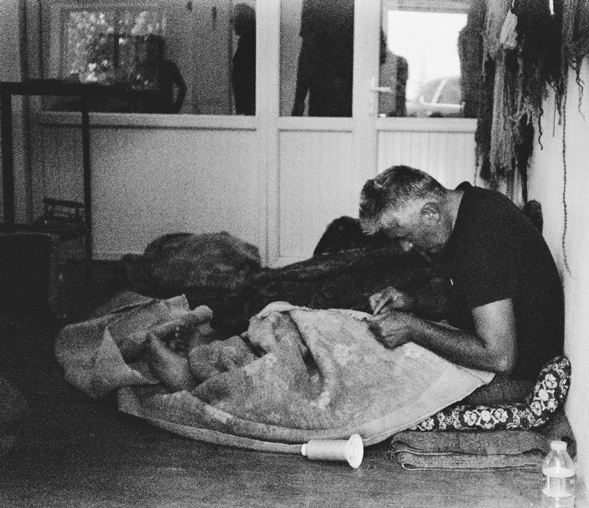 Appraising an antique rug in rug store
