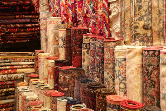 Collection of rolled-up antique rugs