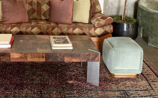 Decorating with rugs in the living room with couch, table, footrest, and rug