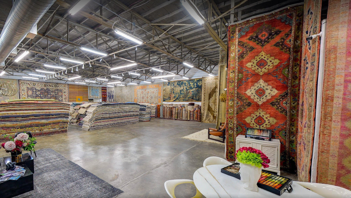 Rugs hanging in Esmaili Rugs showroom